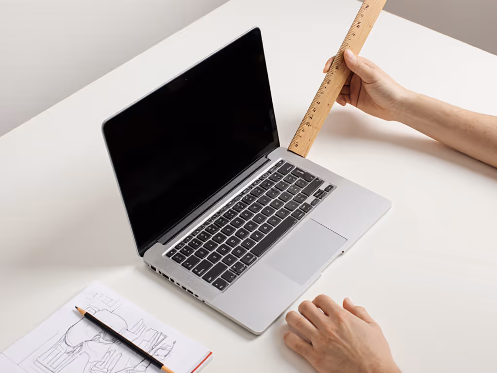 person-measuring-laptop-height-with-ruler